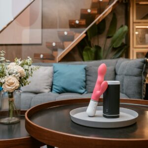 A pink vibrator placed on a table.